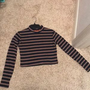 An embroidered ribbed long sleeve crop top.